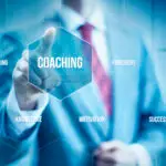 man's hand pushing button 'coaching' on glass wall